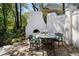 Cozy outdoor dining area featuring a stone fireplace and seating for delightful al fresco meals at 1015 Bedford Gardens Dr, Alpharetta, GA 30022