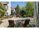 Beautiful backyard pool area with stone patio, lounge chairs, and lush landscaping for a relaxing outdoor experience at 1015 Bedford Gardens Dr, Alpharetta, GA 30022
