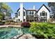 A stunning backyard pool area with lush landscaping and multi-level patio area at 1015 Bedford Gardens Dr, Alpharetta, GA 30022