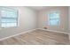 Bright bedroom features new floors and two windows for ample natural light at 2020 Buckingham Ct, Decatur, GA 30035