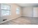 Bright bedroom with updated flooring, neutral walls and natural light from large double-hung windows at 2020 Buckingham Ct, Decatur, GA 30035