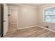 Bedroom with light wood floors leads to laundry room at 2020 Buckingham Ct, Decatur, GA 30035