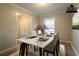 Virtually staged dining room with large table, a window, and neutral décor at 2020 Buckingham Ct, Decatur, GA 30035