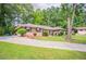 Traditional brick home with mature trees, a long driveway, and well-maintained front lawn at 2020 Buckingham Ct, Decatur, GA 30035