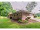Brick home shows attached garage and a well-kept lawn with mature bushes at 2020 Buckingham Ct, Decatur, GA 30035