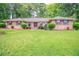 Charming brick home features a lush front lawn and mature landscaping for great curb appeal at 2020 Buckingham Ct, Decatur, GA 30035