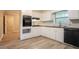 White kitchen with black oven and stovetop range at 2020 Buckingham Ct, Decatur, GA 30035