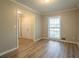Bright living room with wood-look floors and a large window for natural light at 2020 Buckingham Ct, Decatur, GA 30035