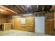 Partially finished basement with wood paneling and exposed ceiling, offering possibilities for customization at 2814 Brackenwood Dr, Snellville, GA 30039