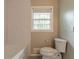 Modern bathroom featuring subway tile, a toilet, and a window for natural light at 2814 Brackenwood Dr, Snellville, GA 30039