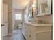 Bathroom features a double vanity with white cabinets, marble countertops, and modern fixtures at 2814 Brackenwood Dr, Snellville, GA 30039