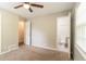 Bedroom with neutral walls, carpet and view of bathroom with toilet at 2814 Brackenwood Dr, Snellville, GA 30039