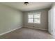 Cozy bedroom with neutral paint, plush carpet, and a bright window at 2814 Brackenwood Dr, Snellville, GA 30039