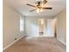 A well-lit bedroom with neutral walls, ceiling fan, and access to a bathroom, offering comfort and convenience at 2814 Brackenwood Dr, Snellville, GA 30039