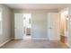 Bedroom with neutral walls, carpet and view of the bathroom and hallway at 2814 Brackenwood Dr, Snellville, GA 30039