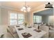 Dining room with a stylish table set, showcasing the beautiful neutral walls and trim details at 2814 Brackenwood Dr, Snellville, GA 30039