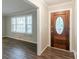 Inviting entryway with beautiful wood flooring and a decorative front door at 2814 Brackenwood Dr, Snellville, GA 30039