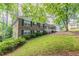 Well-maintained home with a lush lawn and mature trees providing shade at 2814 Brackenwood Dr, Snellville, GA 30039