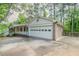 Spacious garage with a wide driveway and convenient side entrance to the home at 2814 Brackenwood Dr, Snellville, GA 30039