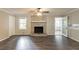 Comfortable living room with a classic brick fireplace and hardwood floors at 2814 Brackenwood Dr, Snellville, GA 30039