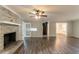 Spacious living room featuring hardwood floors, a brick fireplace, and an open layout at 2814 Brackenwood Dr, Snellville, GA 30039