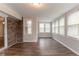Cozy sun room with hardwood floors, brick wall, and multiple windows offering great natural light at 2814 Brackenwood Dr, Snellville, GA 30039