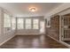 Airy sun room with hardwood floors and neutral walls, featuring large windows and access to the outdoors at 2814 Brackenwood Dr, Snellville, GA 30039