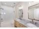 Bright bathroom featuring double vanity with marble countertop, chrome fixtures, and a tub with white tile surround at 3286 Bachelor St, East Point, GA 30344
