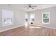 Sunlit bedroom features hardwood floors, large windows with blinds, and a ceiling fan at 3286 Bachelor St, East Point, GA 30344