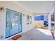 Covered front porch featuring a stylish blue door with glass panels, offering curb appeal at 3286 Bachelor St, East Point, GA 30344