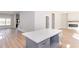Modern kitchen island with light countertops, gray cabinets, and luxury wood flooring throughout the living space at 3286 Bachelor St, East Point, GA 30344