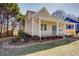 Beautifully landscaped yard with a brick-lined garden bed leading to a covered porch at 3286 Bachelor St, East Point, GA 30344