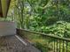Outdoor deck with railings overlooking lush greenery and trees at 3500 Stonewall Pl, Atlanta, GA 30339
