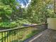 Outdoor deck with railings overlooking a canopy of trees and foliage at 3500 Stonewall Pl, Atlanta, GA 30339