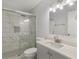Bathroom featuring tiled shower with glass door and a vanity with a sink and light at 3500 Stonewall Pl, Atlanta, GA 30339