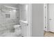 Remodeled bathroom featuring a marble tiled shower with a glass door at 3500 Stonewall Pl, Atlanta, GA 30339