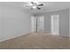 Bedroom with ceiling fan and doors open to reveal closet and bathroom at 3500 Stonewall Pl, Atlanta, GA 30339