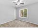 Bedroom with a ceiling fan, a window overlooking trees, and a door to the side at 3500 Stonewall Pl, Atlanta, GA 30339