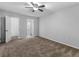 Bedroom with a ceiling fan and a door open to reveal a bathroom and another room at 3500 Stonewall Pl, Atlanta, GA 30339