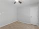 A simple bedroom with a ceiling fan and a white door on the right side of the room at 3500 Stonewall Pl, Atlanta, GA 30339