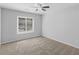 A bright bedroom featuring a ceiling fan and a window that provides natural light at 3500 Stonewall Pl, Atlanta, GA 30339