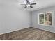 Bedroom with a ceiling fan and a window overlooking the trees at 3500 Stonewall Pl, Atlanta, GA 30339