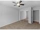 Bedroom features ceiling fan, closet, and neutral carpet at 3500 Stonewall Pl, Atlanta, GA 30339
