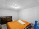 Neutral bedroom with a dark wood dresser, gray carpet, and an orange bedspread at 3500 Stonewall Pl, Atlanta, GA 30339