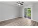 Bright bedroom with hardwood floors, ceiling fan and sliding door leading to balcony at 3500 Stonewall Pl, Atlanta, GA 30339