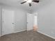 Neutral bedroom featuring carpet floors, a ceiling fan, and natural light from the doorway at 3500 Stonewall Pl, Atlanta, GA 30339