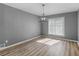 Dining room featuring hardwood floors, a modern light fixture, and window providing natural light at 3500 Stonewall Pl, Atlanta, GA 30339