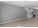 Bright dining room featuring hardwood floors and a modern light fixture next to the white kitchen at 3500 Stonewall Pl, Atlanta, GA 30339