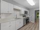 Modern kitchen with white cabinets, stainless steel appliances, and subway tile backsplash at 3500 Stonewall Pl, Atlanta, GA 30339