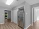 Open-concept kitchen with stainless steel refrigerator and convenient pantry storage at 3500 Stonewall Pl, Atlanta, GA 30339